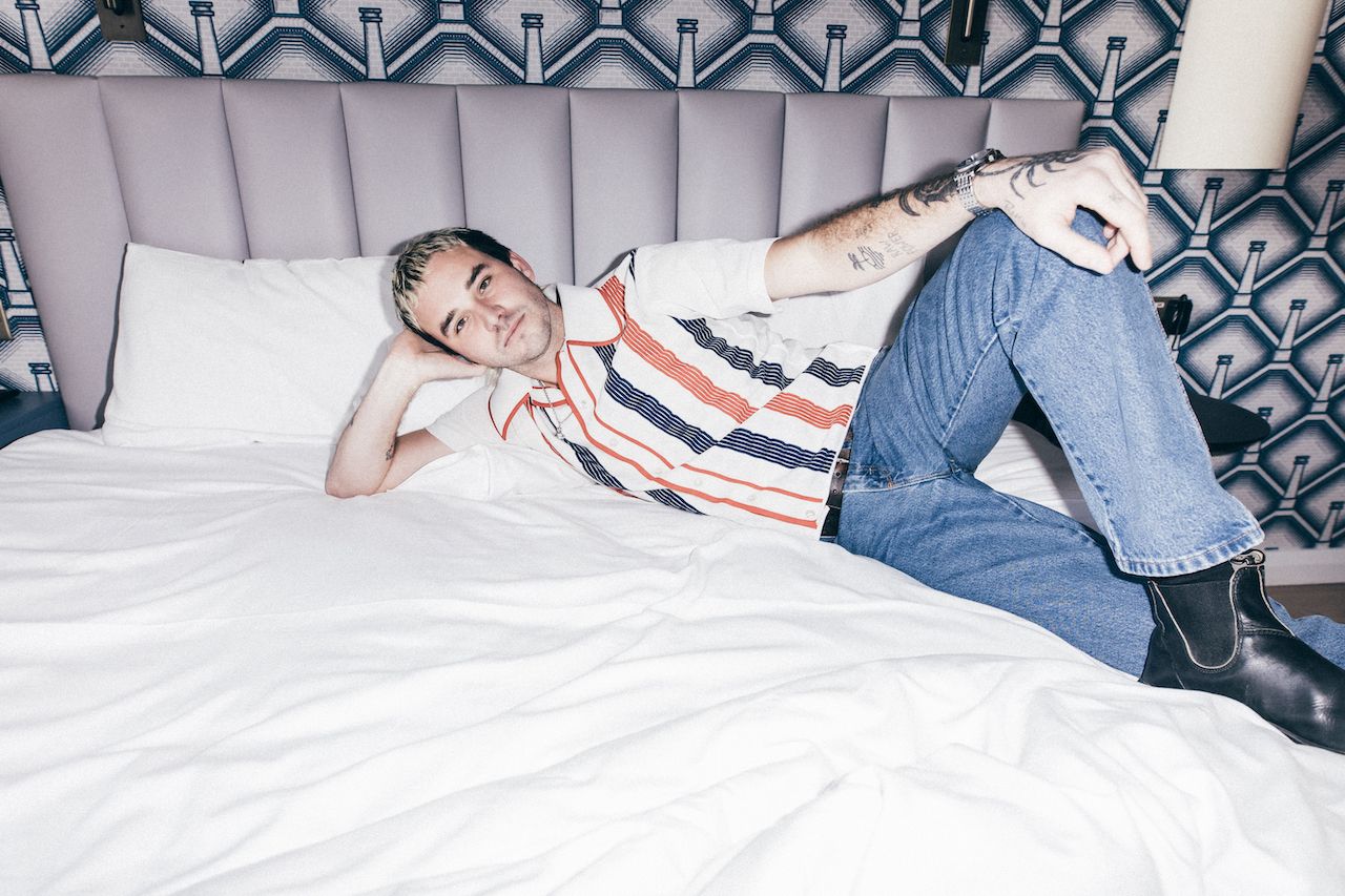 Members of Amyl and the sniffers sat on a bed