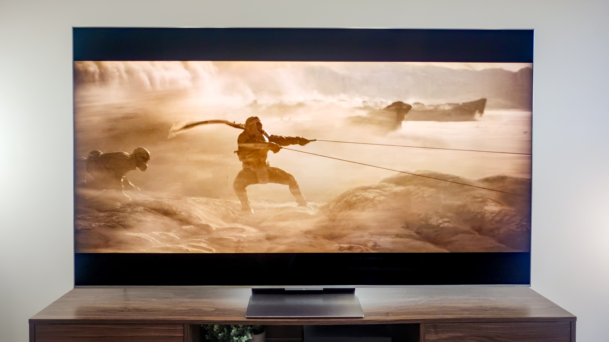 A TCL QM9K TV on a side table