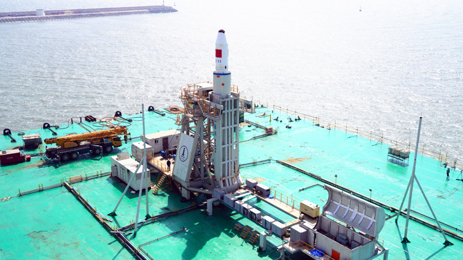 China's Long March 11 rocket stands in launch position on its sea launch platform ahead of a five-satellite launch on April 30, 2022.