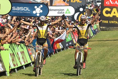 Christoph Sauser and Jaroslav Kulhavy of Investec-Songo-Specialized celebrate as the win the 2015 Absa Cape Epic