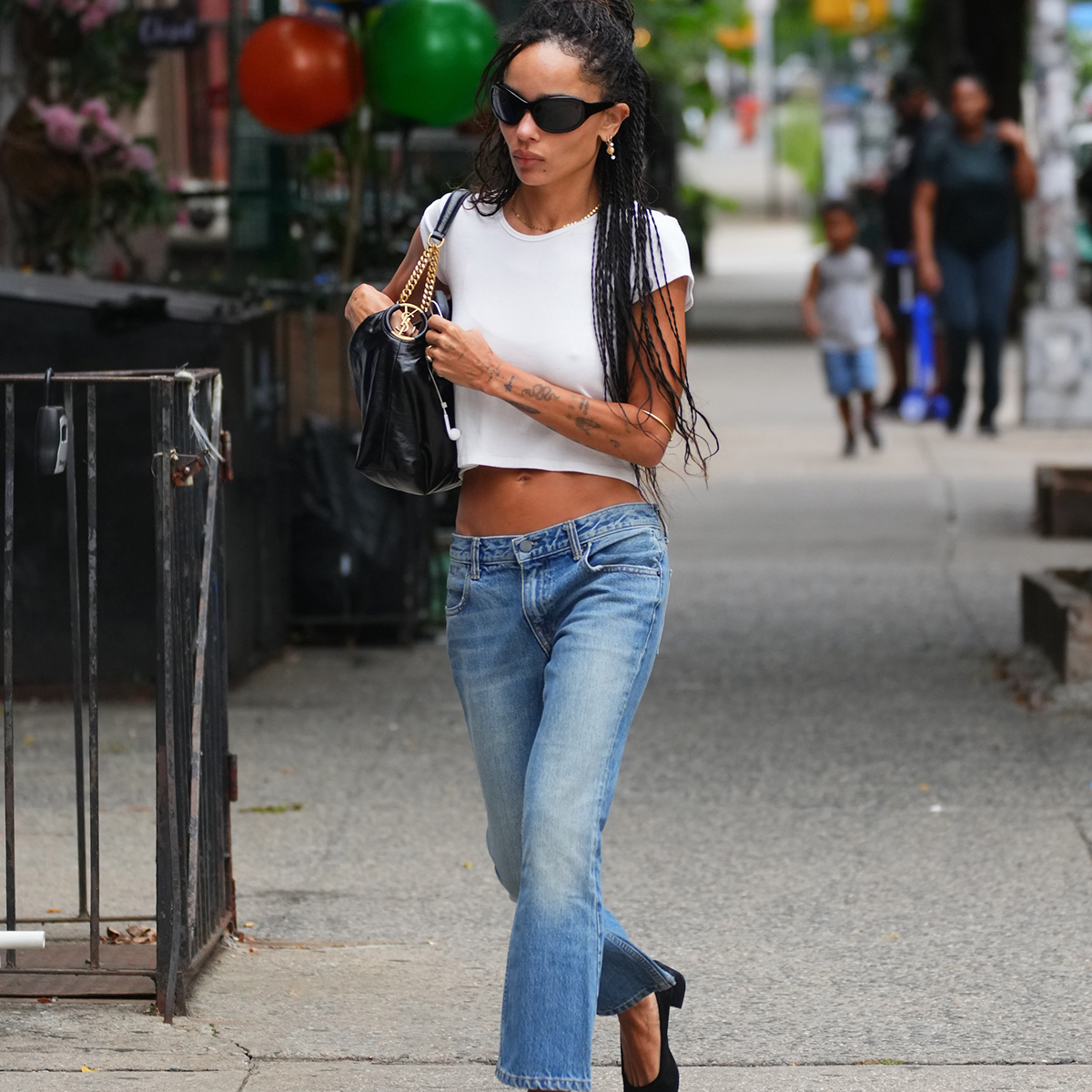 zoe kravitz wearing jeans and a white t shirt