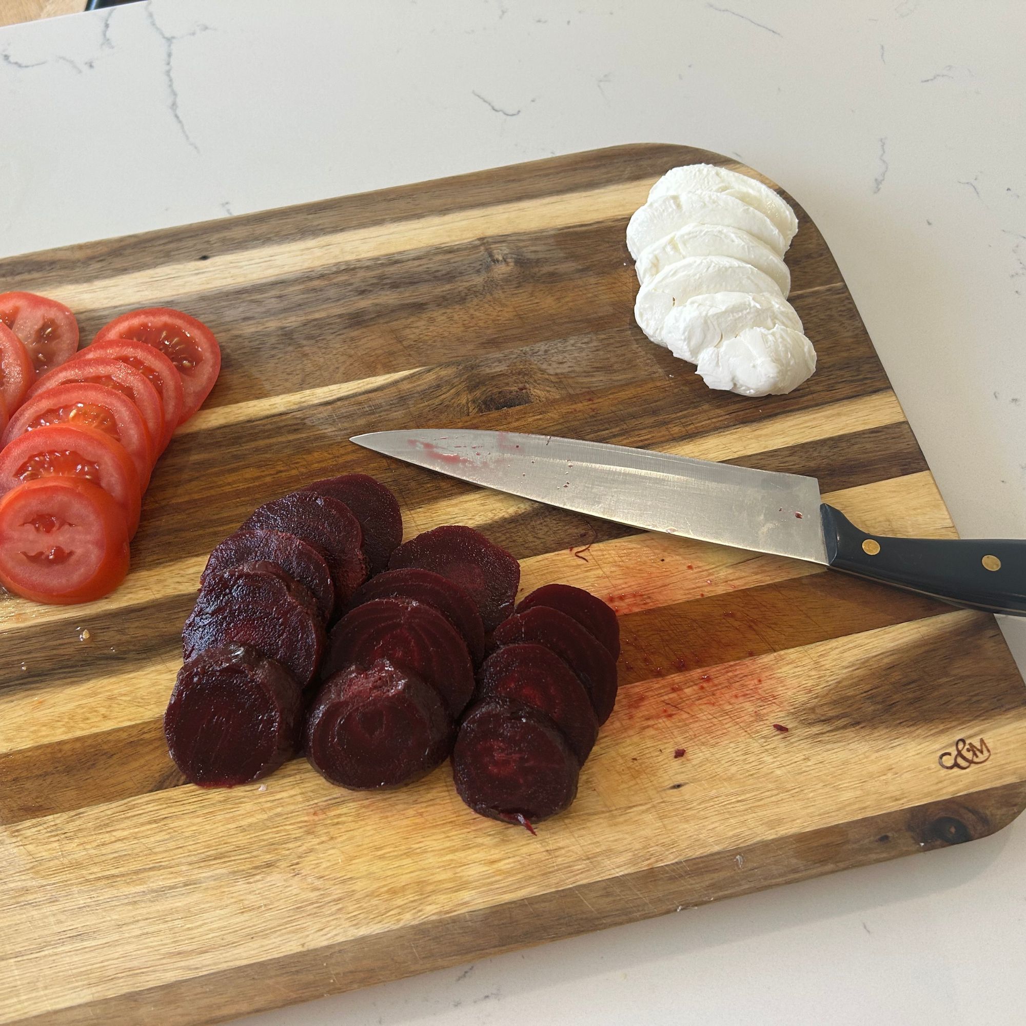 Cole &amp;amp; Mason wooden chopping board with beetroot, tomato and mozzarella on