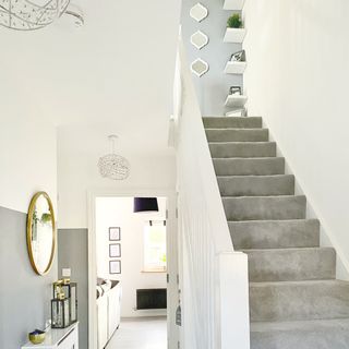 hallway with grey carpet on stairs