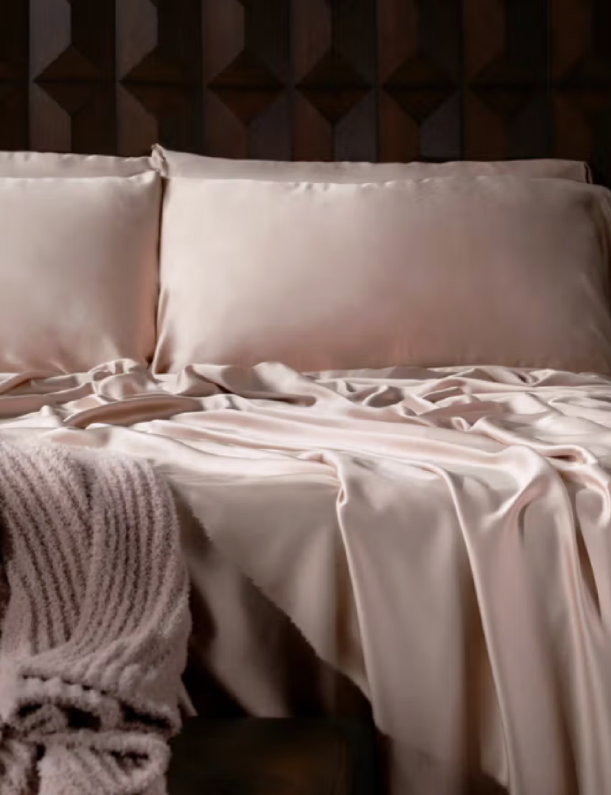 Blue bamboo viscose bed sheets pictured against a wooden bed frame