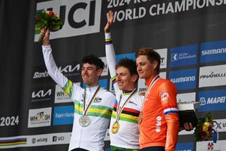 Tadej Pogačar, Ben O'Connor and Mathieu van der Poel on the podium.