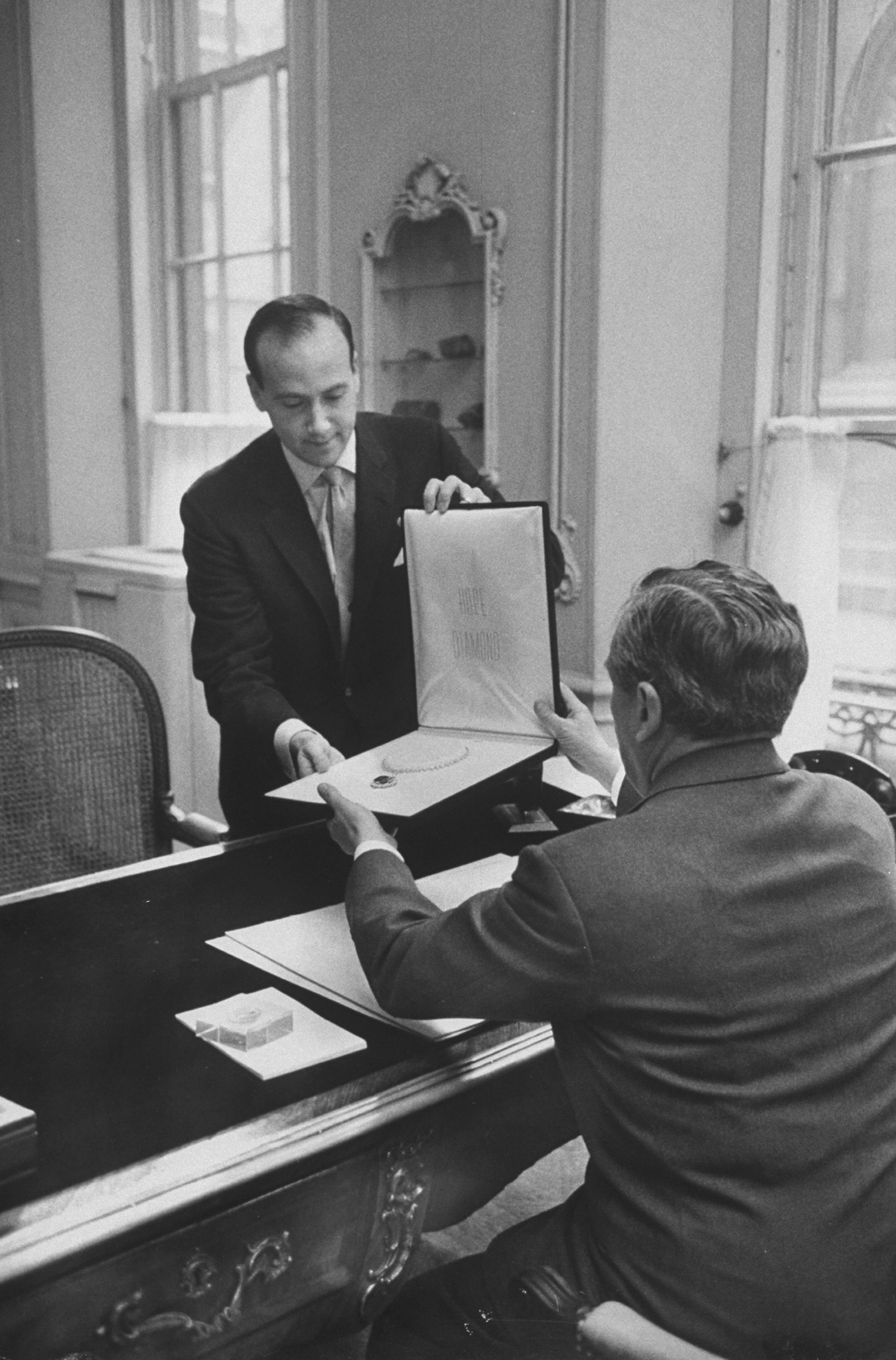 Black and white photograph of Richard Winston showing Harry Winston the Hope Diamond in necklace form