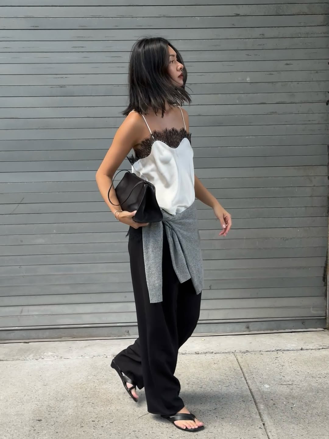 Mimi in black leather flip-flops