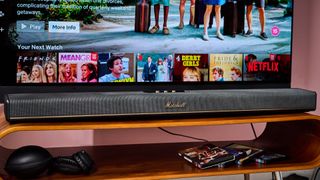 Marshall Heston 120 below TV with Marshall headphones and 4k UHD blu-rays below that