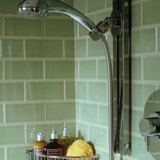 bathroom with green tiles and shower