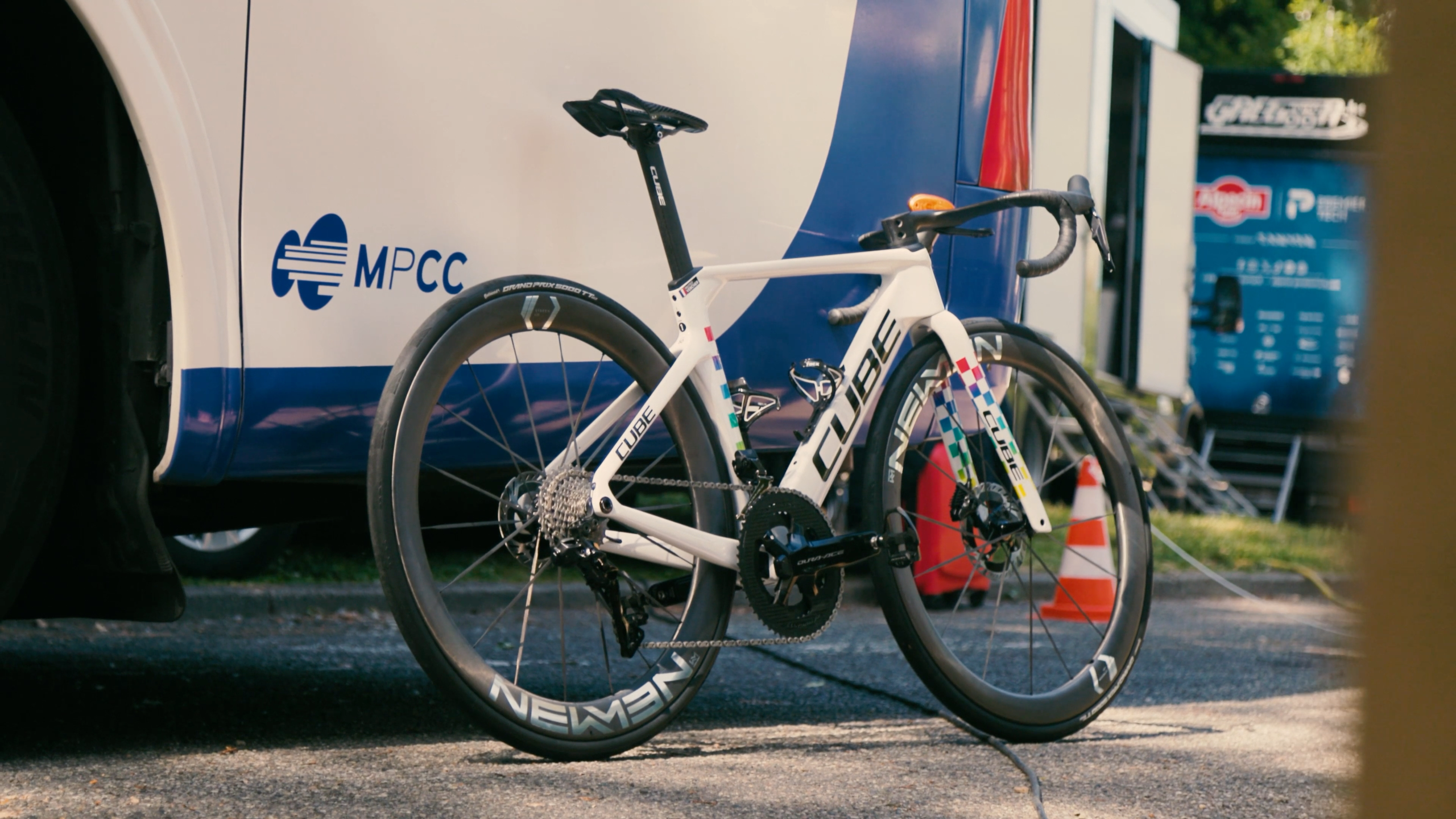 A blue, white and red road bike in an urban environment