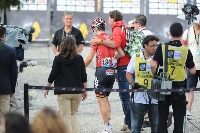 Tony Gallopin (Lotto Belisol) is led away to accept the maillot jaune