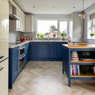 blue and white painted kitchen with island and wooden floor