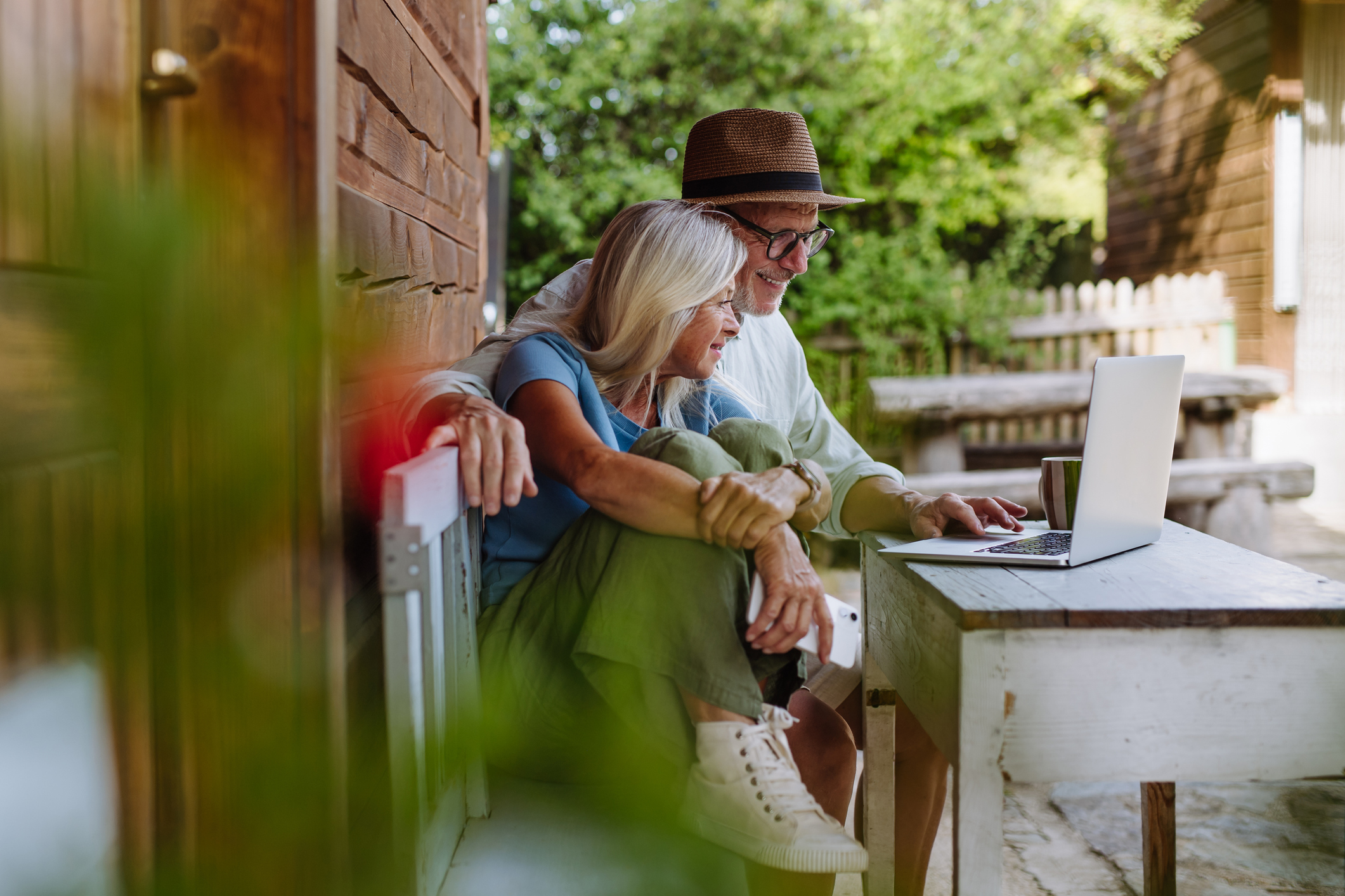 A couple using a laptop to connect with family and friends.