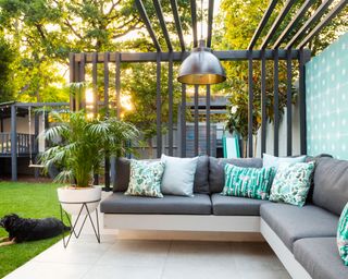 L-shaped bench design with cushions and pergola