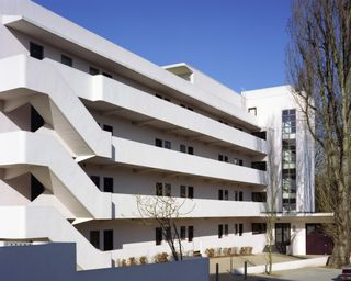 White modernist building with rounded stairs