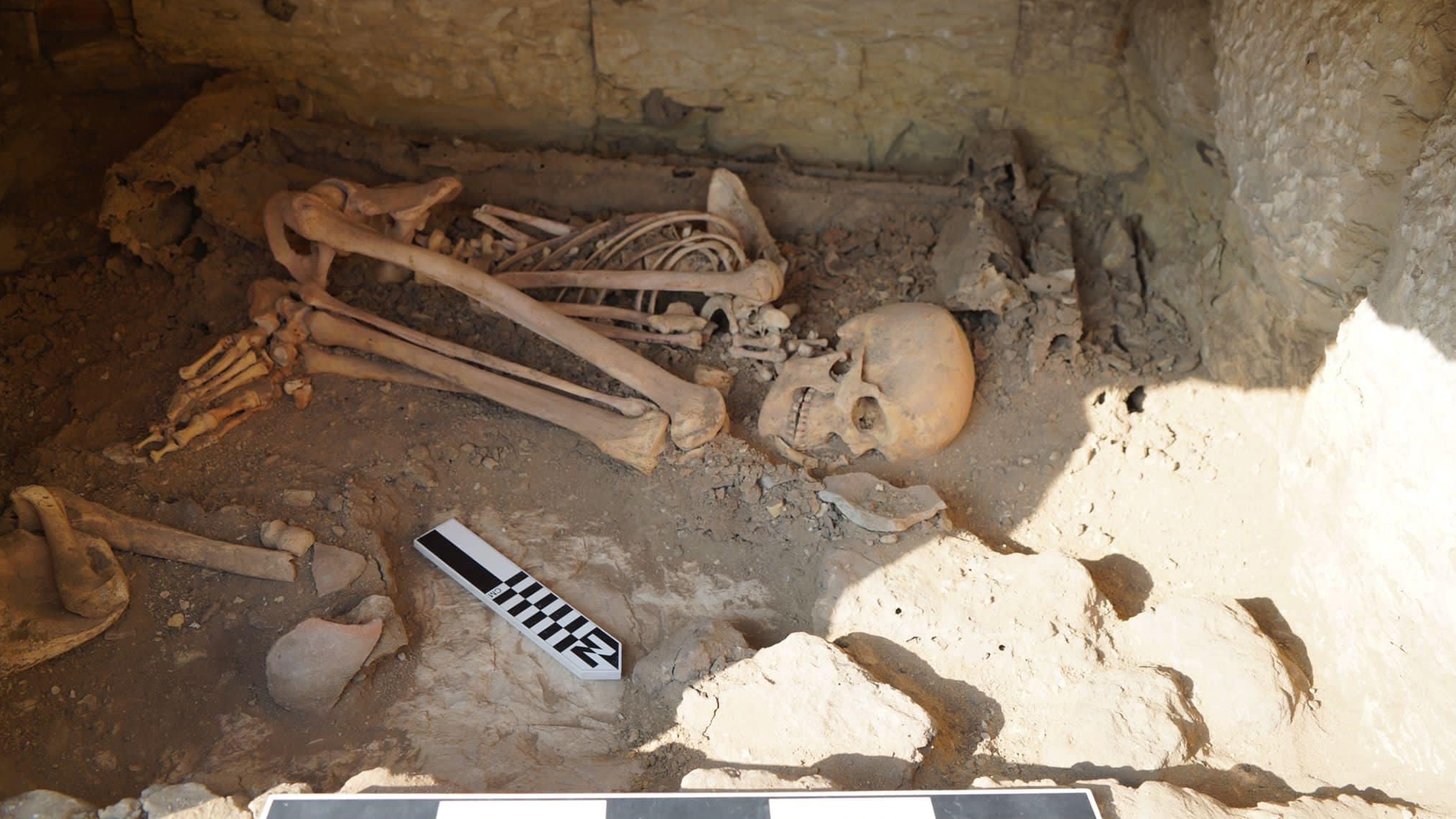 Human skeletal remains found in the fetal position at an archaeological excavation site.
