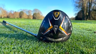 Cobra LTDx Driver and its black and yellow clubhead resting on the golf course
