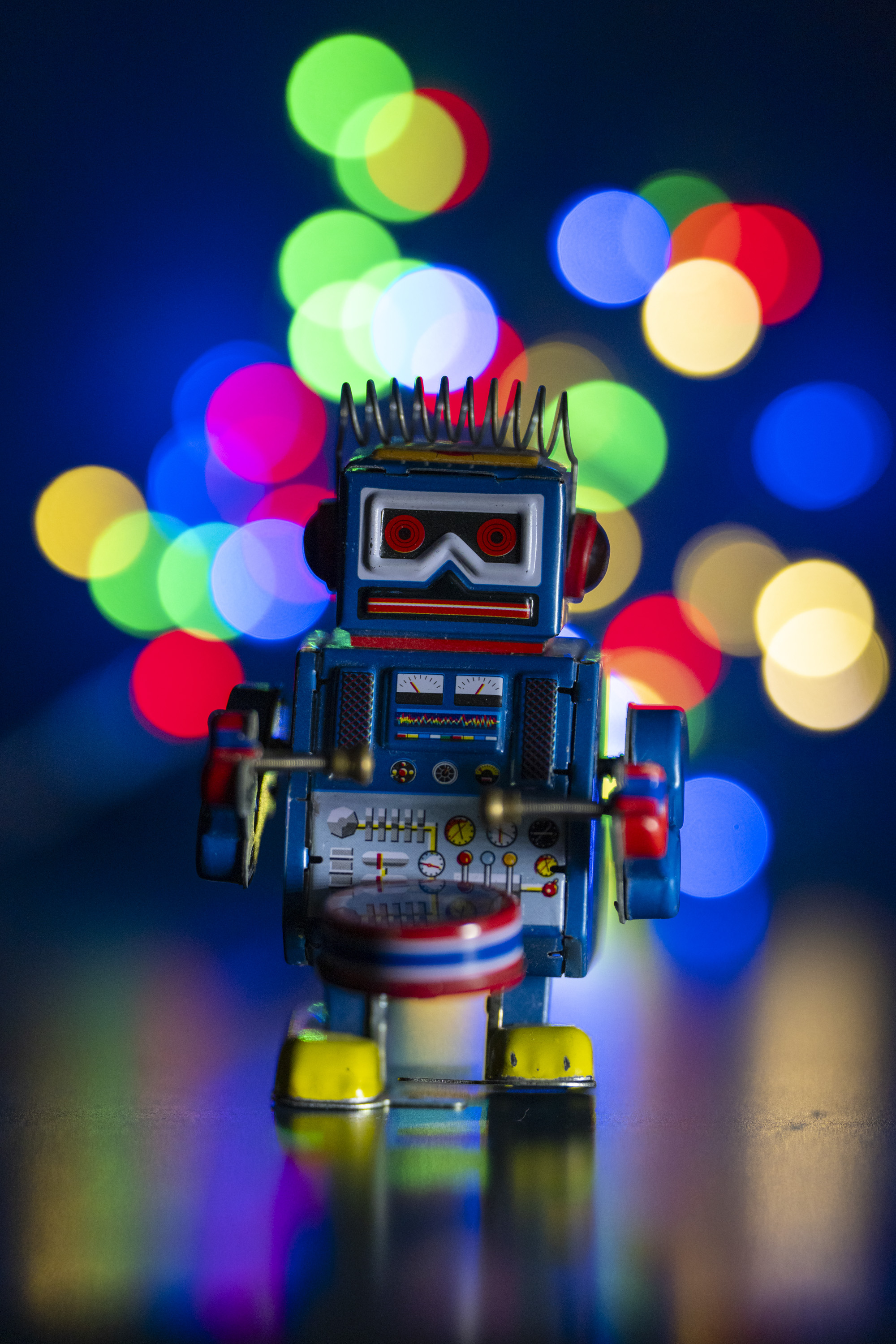 A test shot of a toy metal robot with string lights set up behind it to produce bokeh at different apertures
