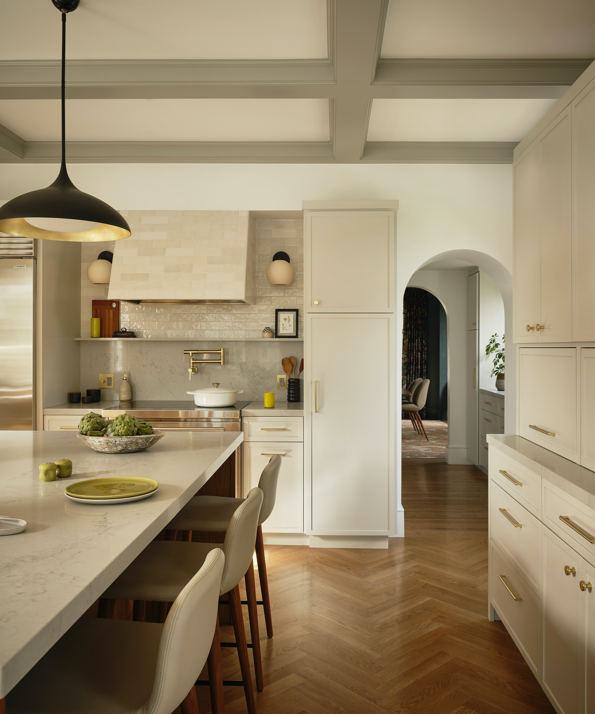 off-white kitchen with wood herringbone floors