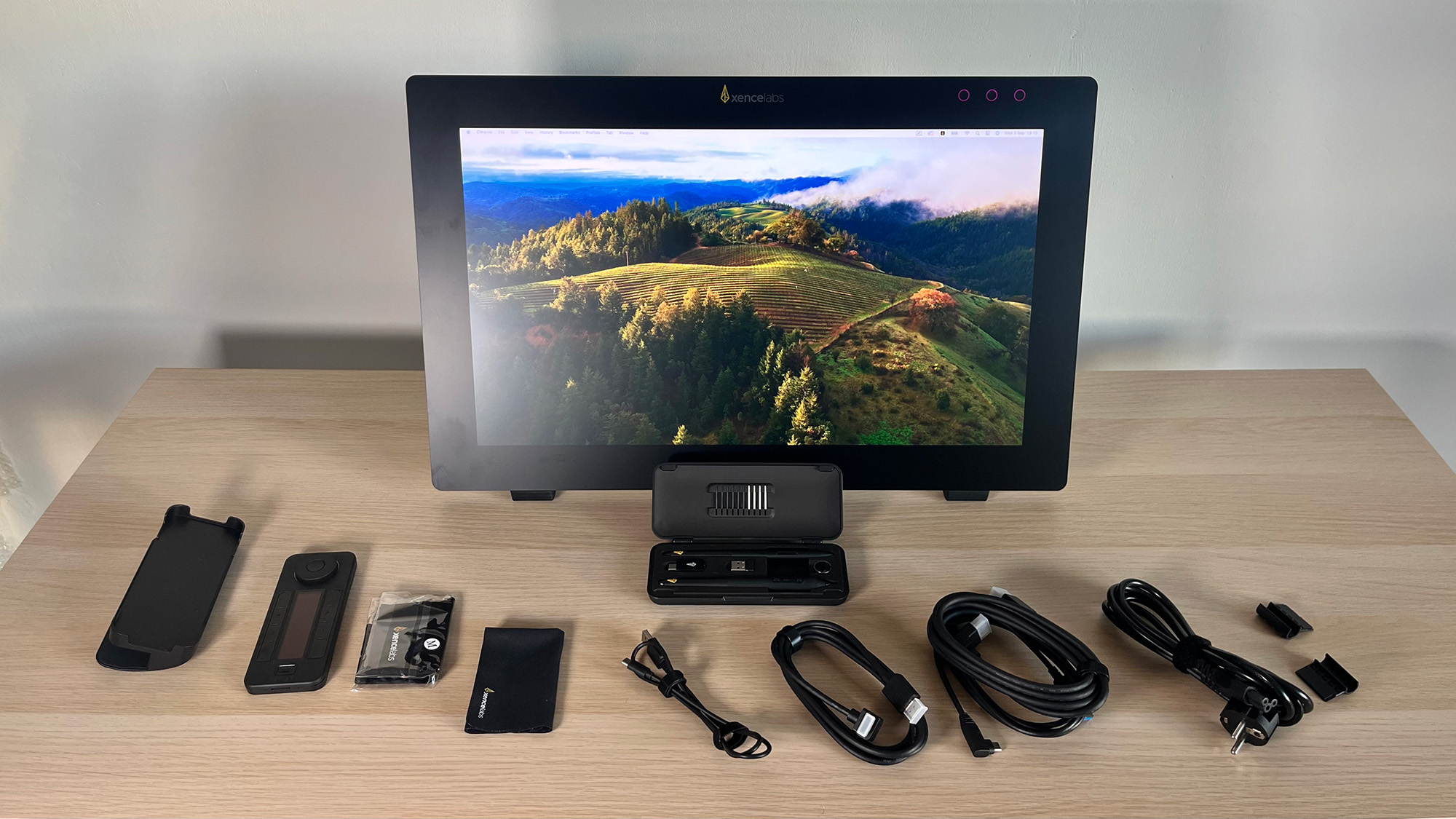 Xencelabs Pen Display 24+ standing on desktop surrounded by cables and accessories