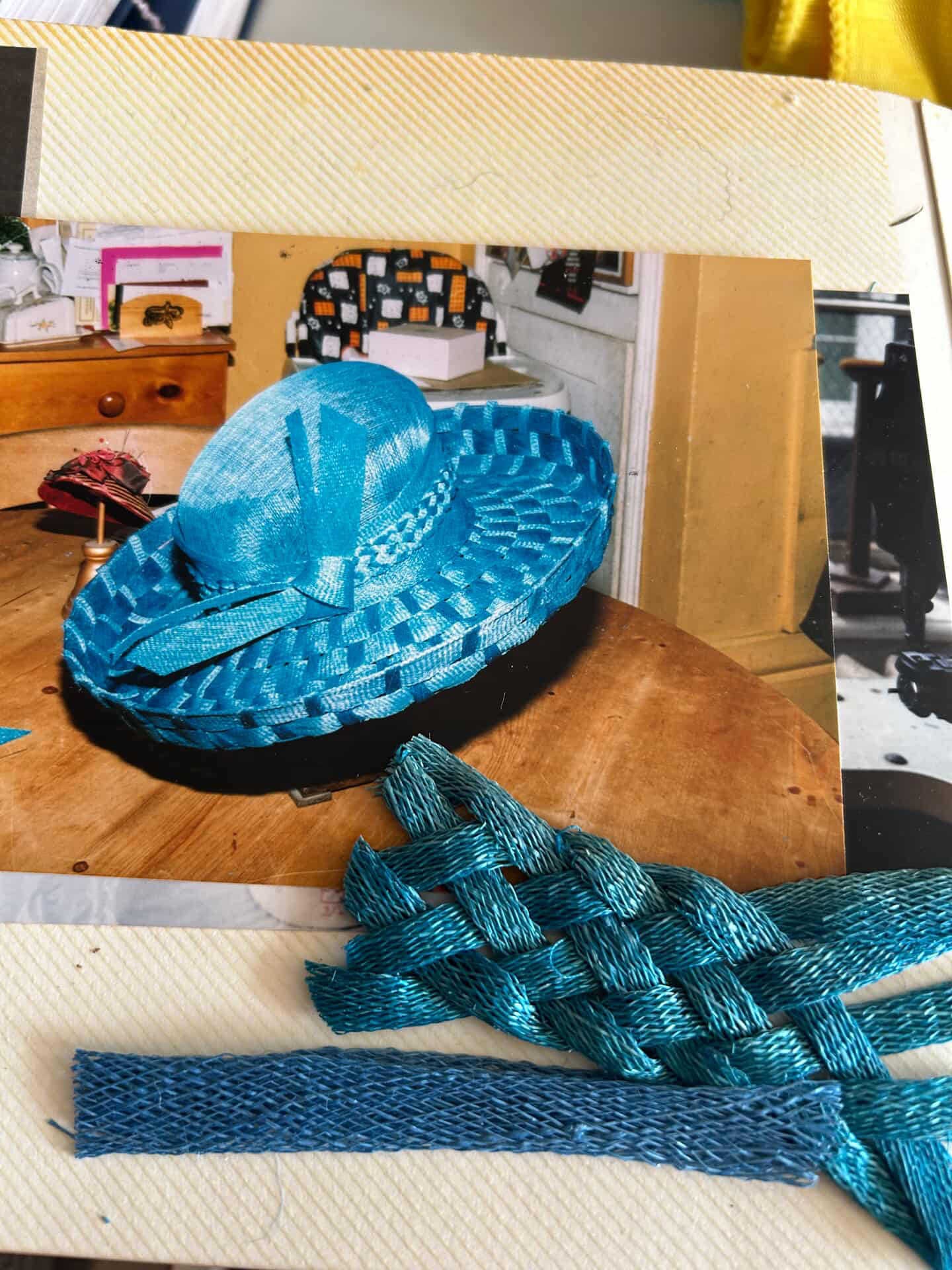 a photo of a scrapbook with braided blue fabric and a picture of a hat