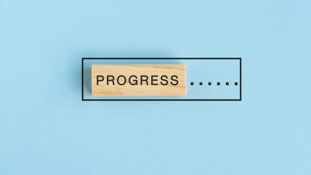 An artistic image where a digital progress bar is represented by a physical wooden block.