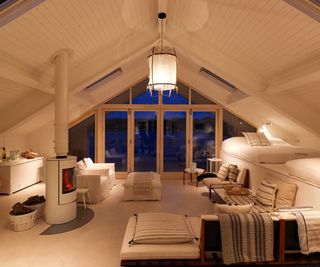 Contemporary upper floor of home in wood and white with warn subtle lighting