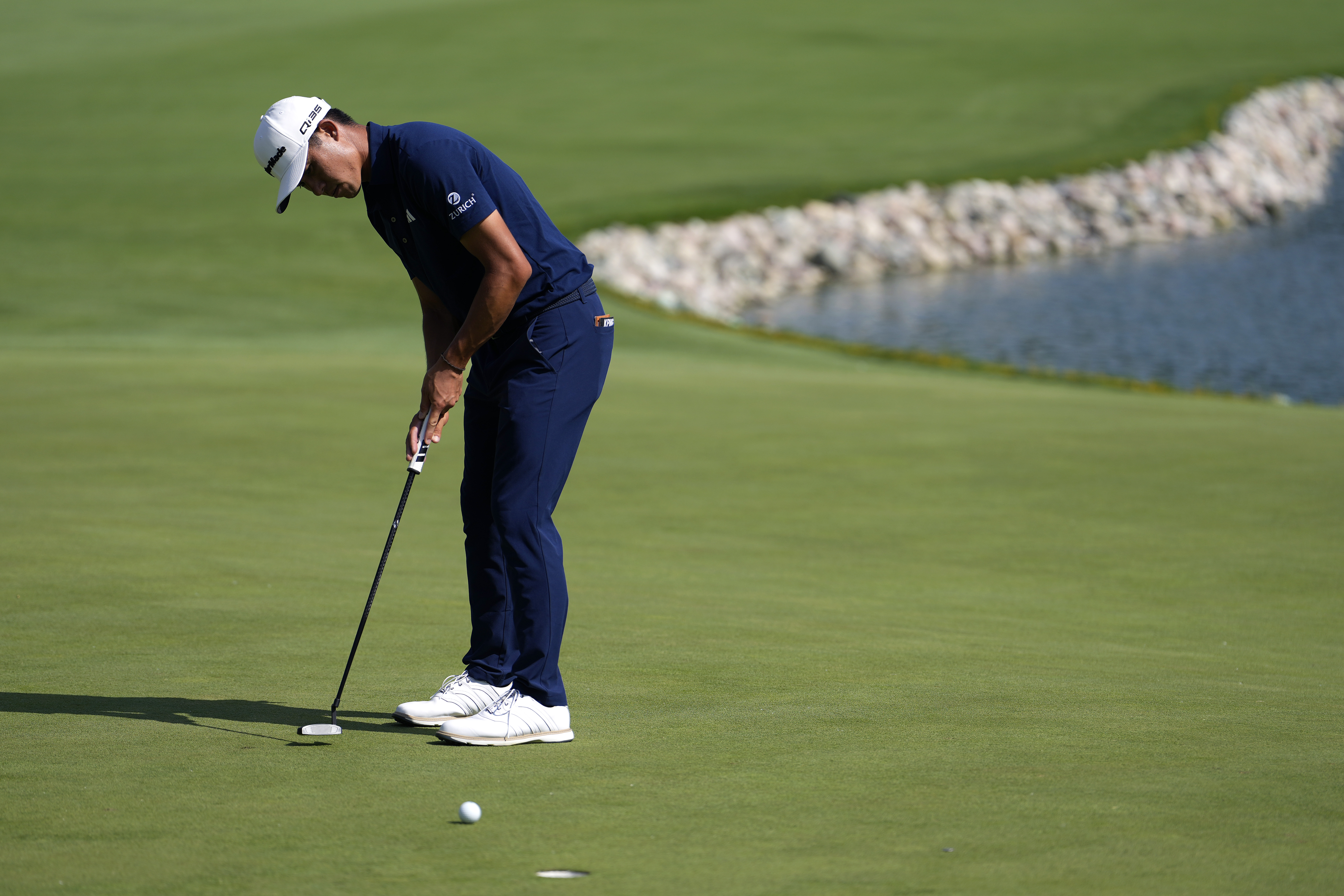 Collin Morikawa lines up a putt