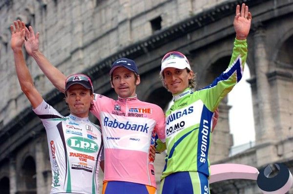 With the Colosseum in the background the top three of the Giro d'Italia Danilo Di Luca, Denis Menchov and Franco Pellizotti (L-R) wave to the crowd.
