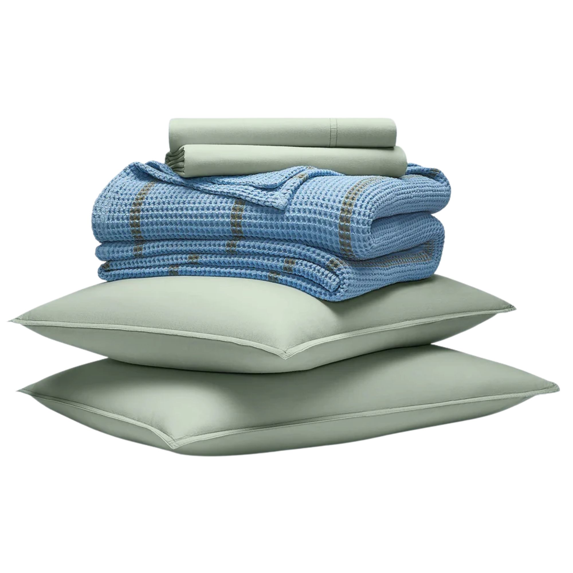 A stack of sage green Brooklinen bedding and a blue waffle blanket with a green stripe.