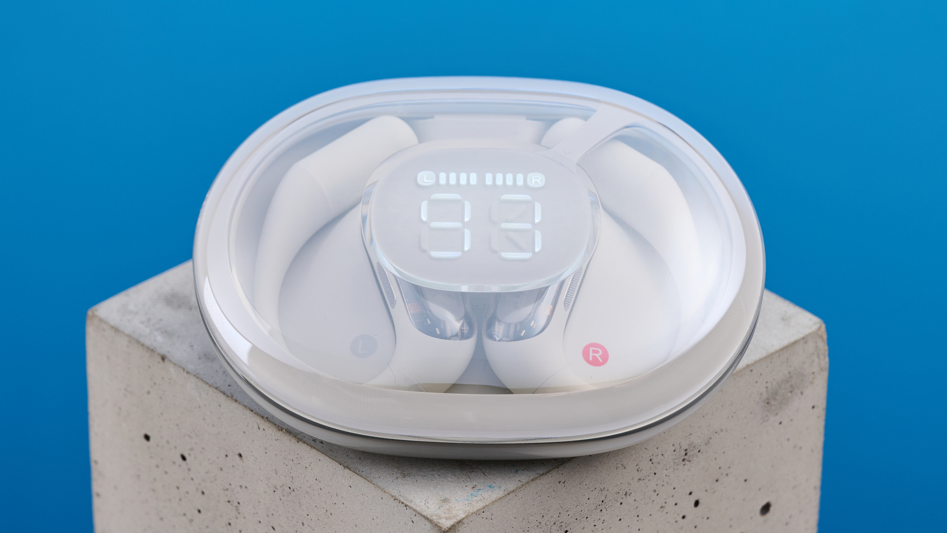 AceFast AceFit Pro open earbuds and the light up charging case photographed in front of a blue background.