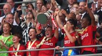 Katie Zelem lifts the Women's FA Cup trophy after Manchester United's 4-0 win over Tottenham at Wembley in May 2024.