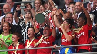 Katie Zelem lifts the Women's FA Cup trophy after Manchester United's 4-0 win over Tottenham at Wembley in May 2024.