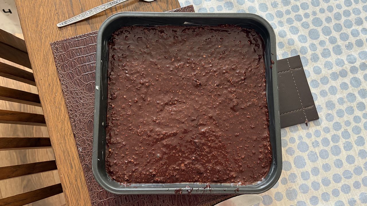 A close up of a baking pan with brownie mixture in it