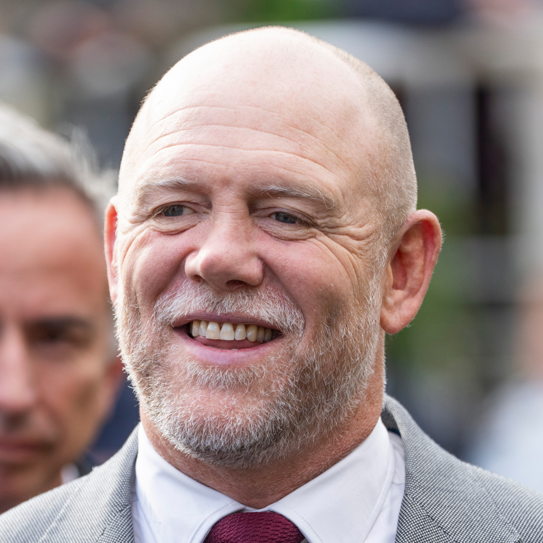Mike Tindall wearing a gray suit and smiling