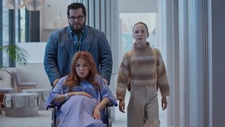 Josh Gad as Gary, Isla Fisher as Mary and Ariel Donoghue as Emma walking in a hospital in Wolf Like Me season 2