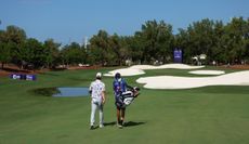 Jeff Winther and his caddie walk down the fairway