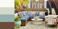 An outdoor living space with a cornflower blue corner sofa, lilac patterned cushions, a cream round coffee table, and a modern minimalist armchair with a rust-colored frame and cream cushion. 