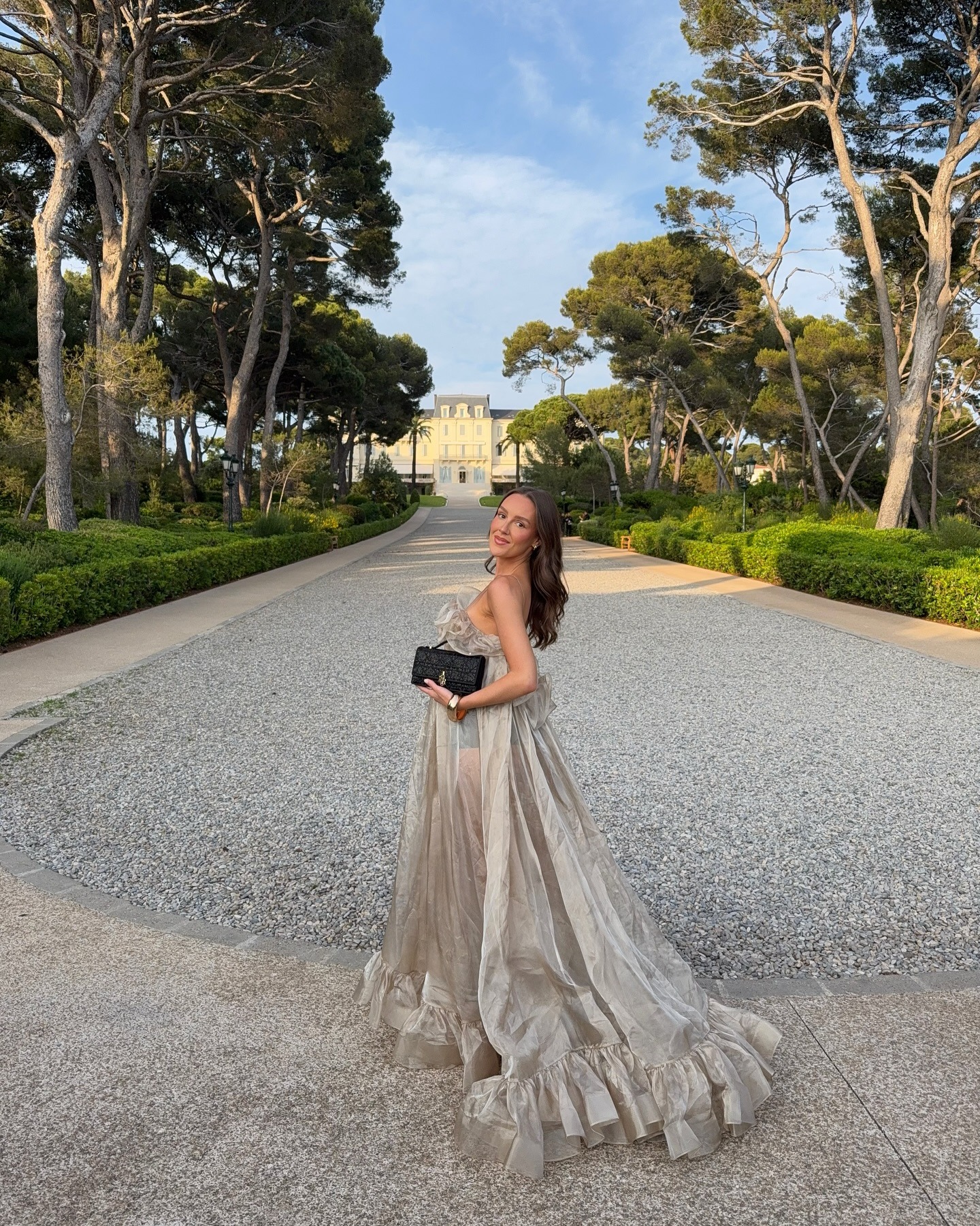 Influencer Emma Leger at a hotel in the South of France wearing a golden dress