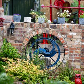 B&Q Gardener of the Year Odette and Rob's zoned garden brick wall with potted plants