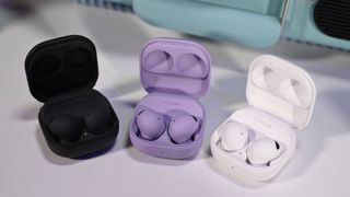 Galaxy Buds 2 Pro in black, purple and white colorways on a white table