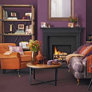 living room with deep velvet walls and orange armchair