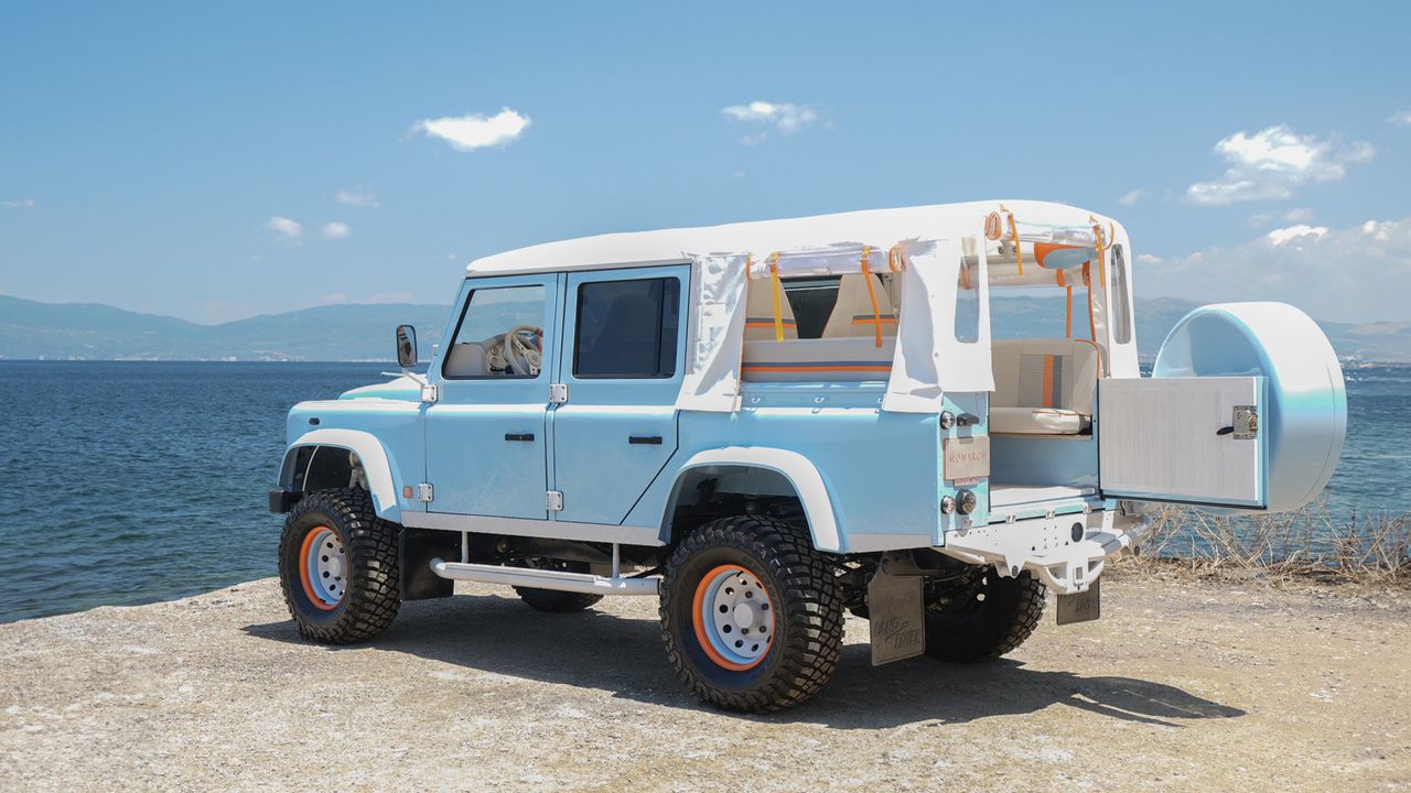 Pale blue Land Rover by sea