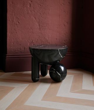 black marble table against pink wall