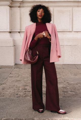 @emmanuellek_ wears a burgundy top and trousers with a pink blazer