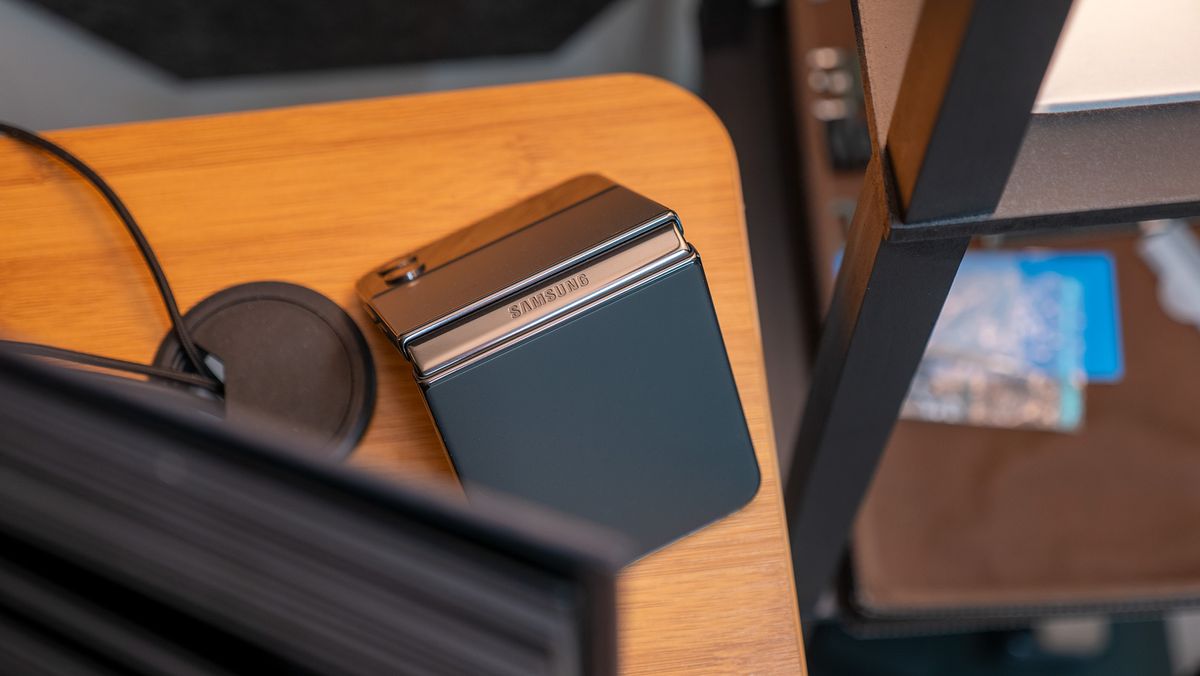 A Samsung Galaxy Z Flip 4 in tent mode on a desk