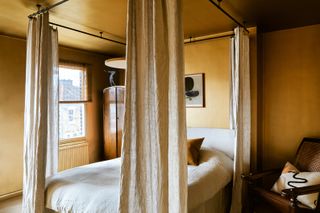 Gold bedroom with four poster bed