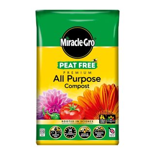 Yellow and green bag of Miracle-Gro compost with flowers and vegetables on the front of it