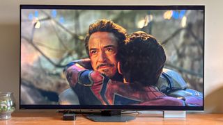 Hisense U8N Mini-LED TV shown in a living room playing Avengers: Endgame