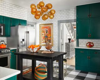 a green kitchen with orange accent colors